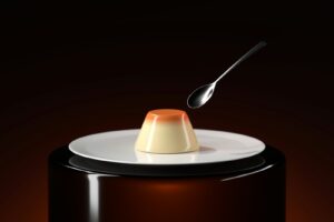 A spoon with a dessert on top of it